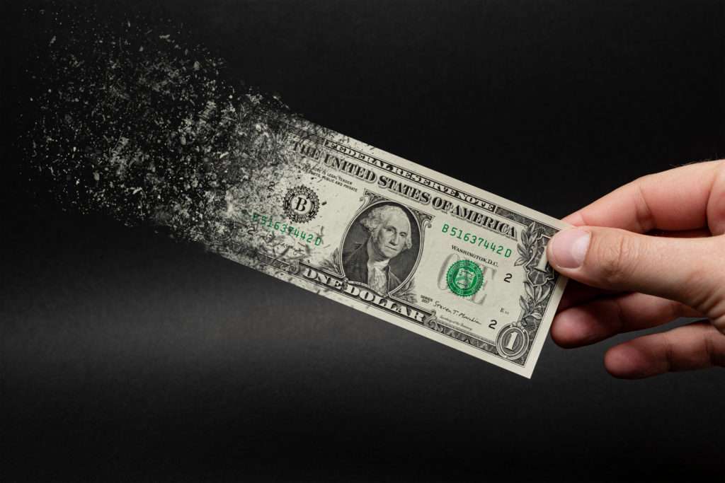 U.S. dollar bill dissolving